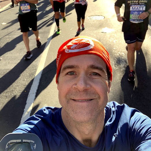 A photo of Ned Vickers running in a marathon